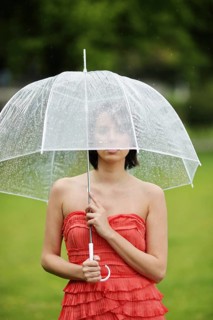 Woman with umbrella outside in a summer rain