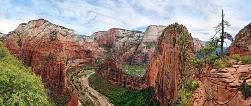 Panoramic view of Zion Canyon the Angels Landing rock formation with sheer cliffs on either side