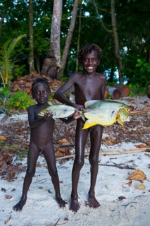 Boys proudly showing the fish they caught