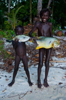 Boys proudly showing the fish they caught