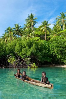 Local boys in a canoe in the Marovo Lagoon