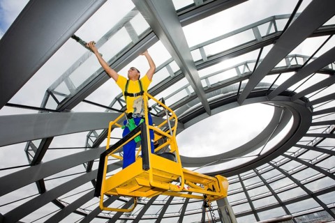 Window cleaner cleaning the glass panels of the dome of the Reichstag building
