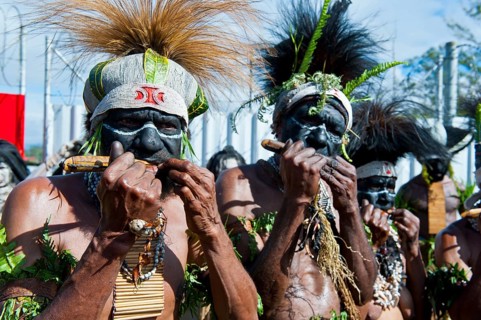 Members of a tribe in colourfully decorated costumes with face paint at the traditional sing-sing gathering