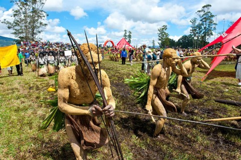 Members of a tribe in colourfully decorated costumes with face and body paint at the traditional sing-sing gathering