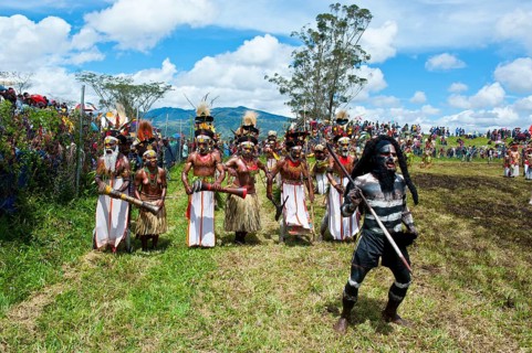 Members of a tribe in colourfully decorated costumes with face and body paint at the traditional sing-sing gathering