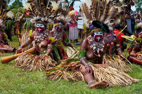 Women in colourfully decorated costumes with face paint at the traditional sing-sing gathering
