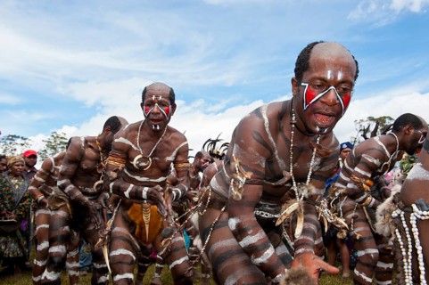 Members of a tribe with face and body paint at the traditional sing-sing gathering