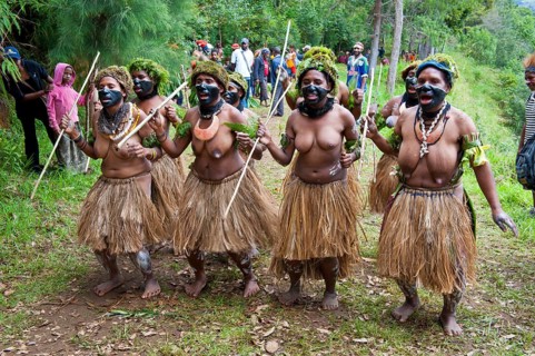 Colourfully decorated women with face paint are celebrating at the traditional Sing Sing gathering in the highlands