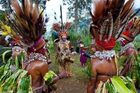 Tribal members in colourful decorations and face paint are celebrating at the traditional Sing Sing gathering in the highlands