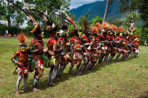 Tribal members in colourful decorations and face paint are celebrating at the traditional Sing Sing gathering in the highlands