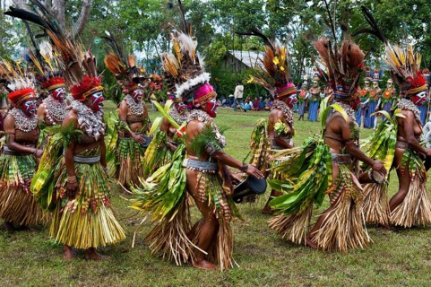 Tribal members in colourful decorations and face paint are celebrating at the traditional Sing Sing gathering in the highlands