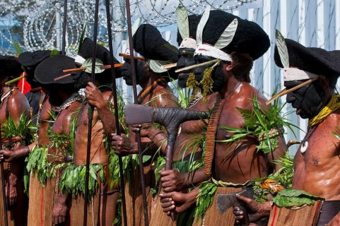Members of a tribe in colourfully decorated costumes with face paint at the traditional sing-sing gathering