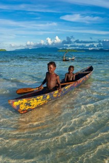 Boys in a canoe in the Marovo Lagoon