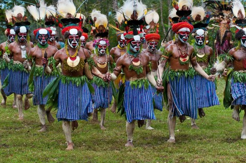 Men in colourfully decorated costumes with face paint are celebrating at the traditional Sing Sing gathering in the highlands