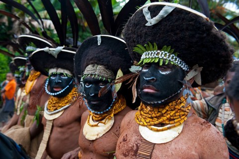 Black decorated and painted tribesmen celebrating the traditional Sing Sing in the highlands