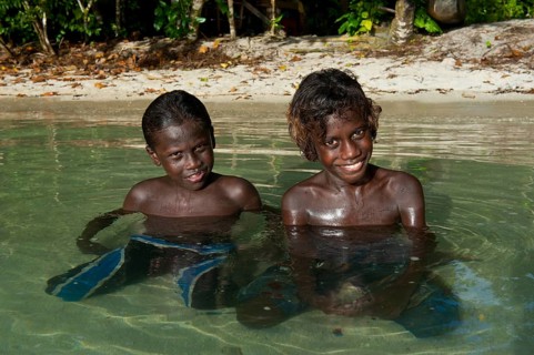 Smiling local boys in the water of the Marovo Lagoon