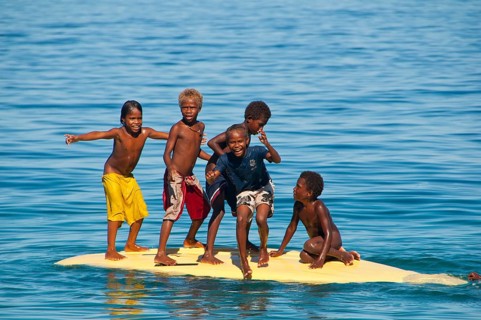 Children playing with a surf board