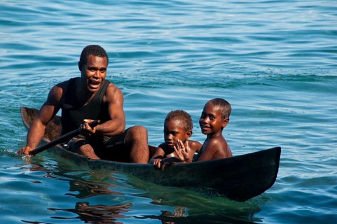 A man and two children in a canoe