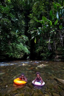 Children bathing in front of the Millennium Cave