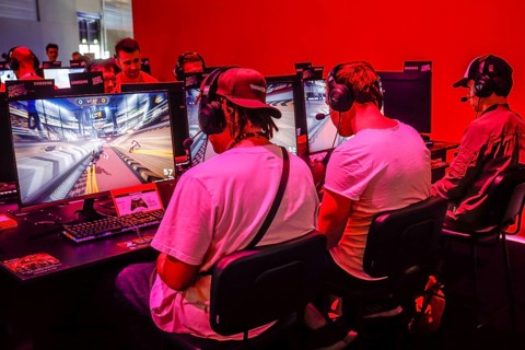 Young visitors at the computer game in front of screens