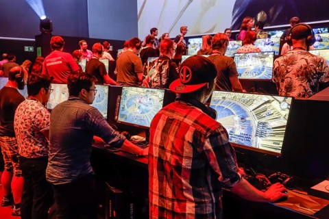 Visitors at the Final Fantasy computer game in front of screens
