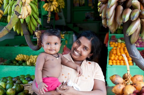 Female vendor holding her baby