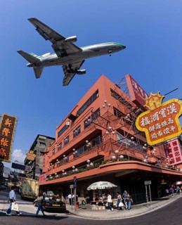 Cathay Pacific aircraft approaching Kai Tak Airport over the rooftops of Kowloon