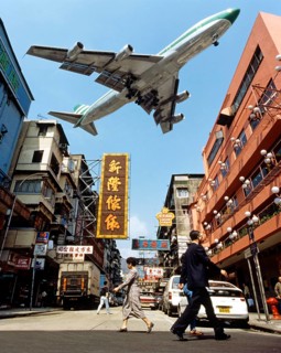 Cathay Pacific aircraft approaching Kai Tak Airport over the rooftops of Kowloon