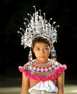 Girl of the ethnic group of the Iban people wearing traditional dress with a headdress