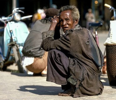Men of the people of Cham or Tscham people squatting ont he ground