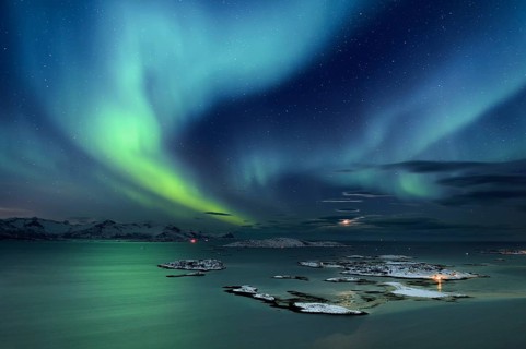 Fjord with islands in winter and the northern lights
