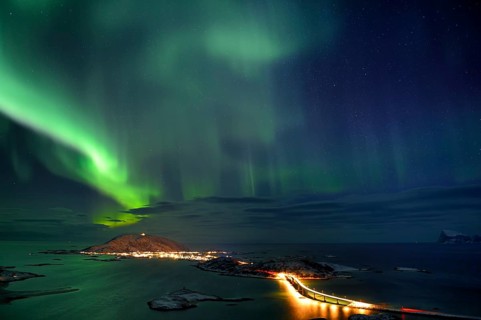 Fjord with islands in winter and the northern lights