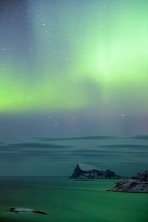 Fjord with islands in winter and the northern lights