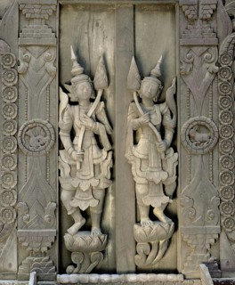 Carved figures on a teak wood door