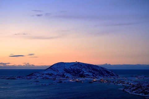 Fjord with mountains in winter at sunset
