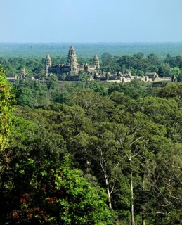 View from Phnom Bakheng towards Khmer Temple with its towers rising out of the jungle