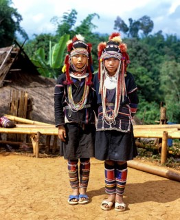 Two Akha girls in a mountain village in traditional costume and headdress