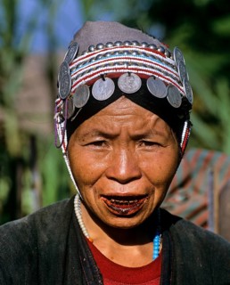 Akha woman with traditional clothing and headdress with Silbergmuenzen