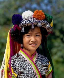 Lisu girl wearing a colourful headdress and the traditional costume of the mountain people