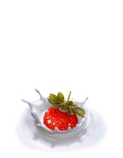 Strawberry falling into milk