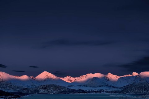 Fjord with mountain peaks during the blue hour