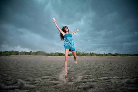 Girl jumping on a beach