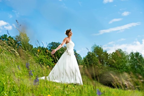Bride standing on a meadow in Tyrol