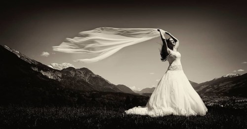 Bride holding a flowing scarf in the Tyrolean Alps