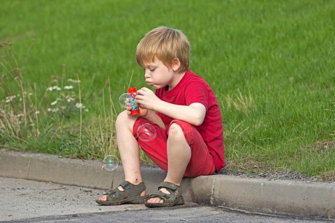 Young boy blowing bubbles