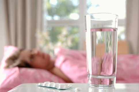 Glass of water with tablets