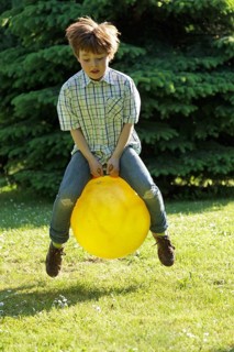 Boy jumping with a hop ball