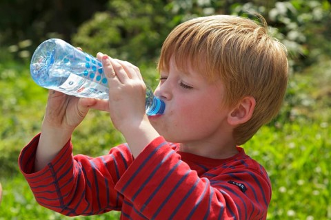 Young boy drinking water