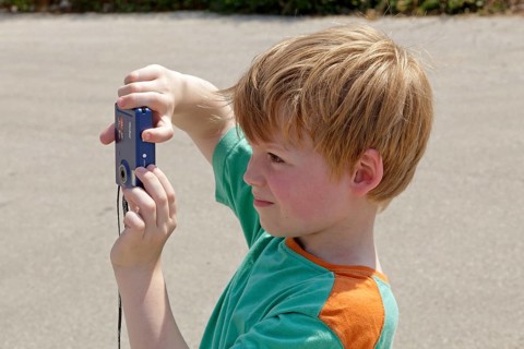 Young boy taking pictures