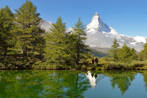 Hiker standing at Lake Grindjisee
